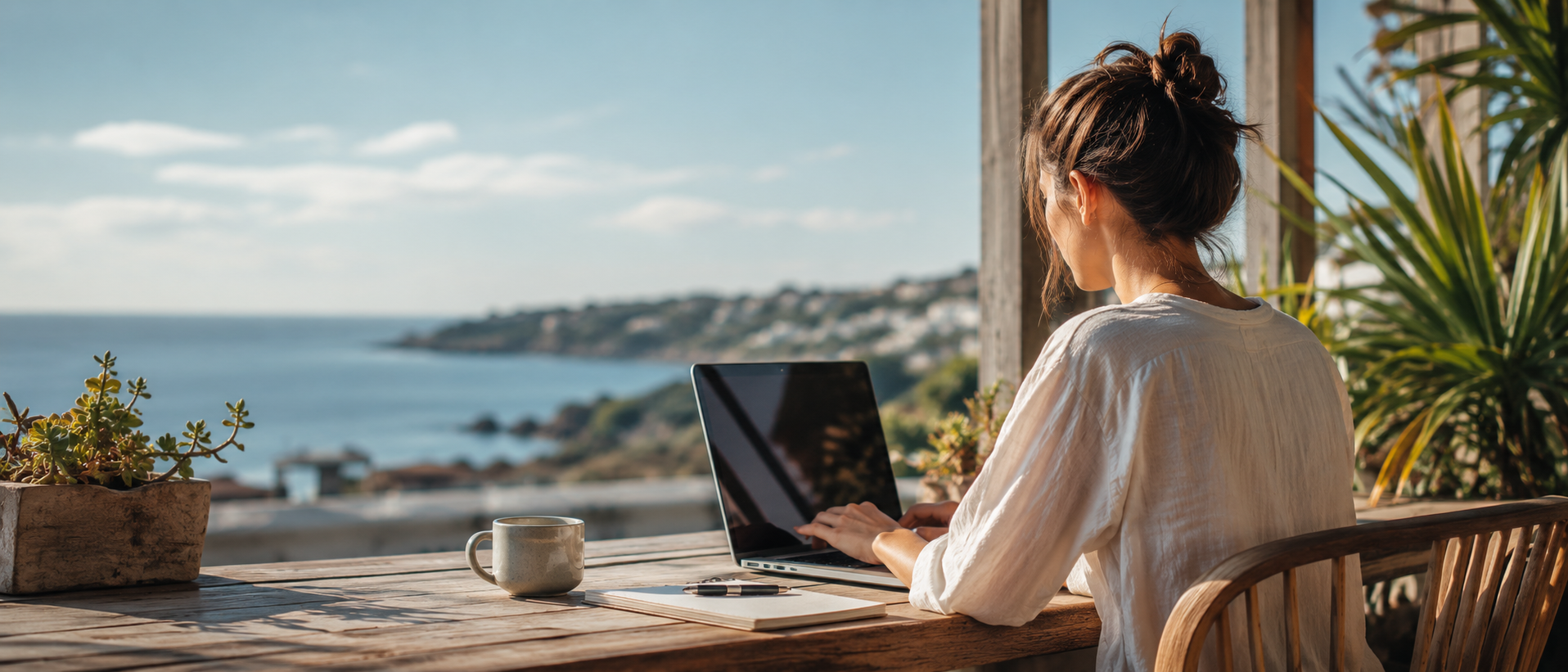 Freelancer working on a laptop by the sea, representing freedom from endless online courses and taking action instead.